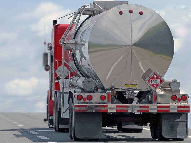 Cargo tank truck transporting flammable material on a highway