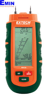 Technician checking a moisture meter used for wood and construction material inspection