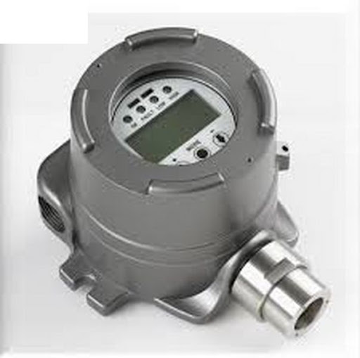 Technician checking a fixed gas detection system in an industrial environment