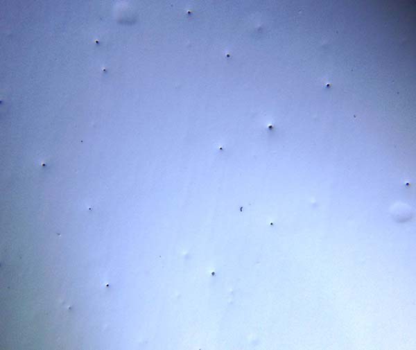 Coated surface with visible pinholes
