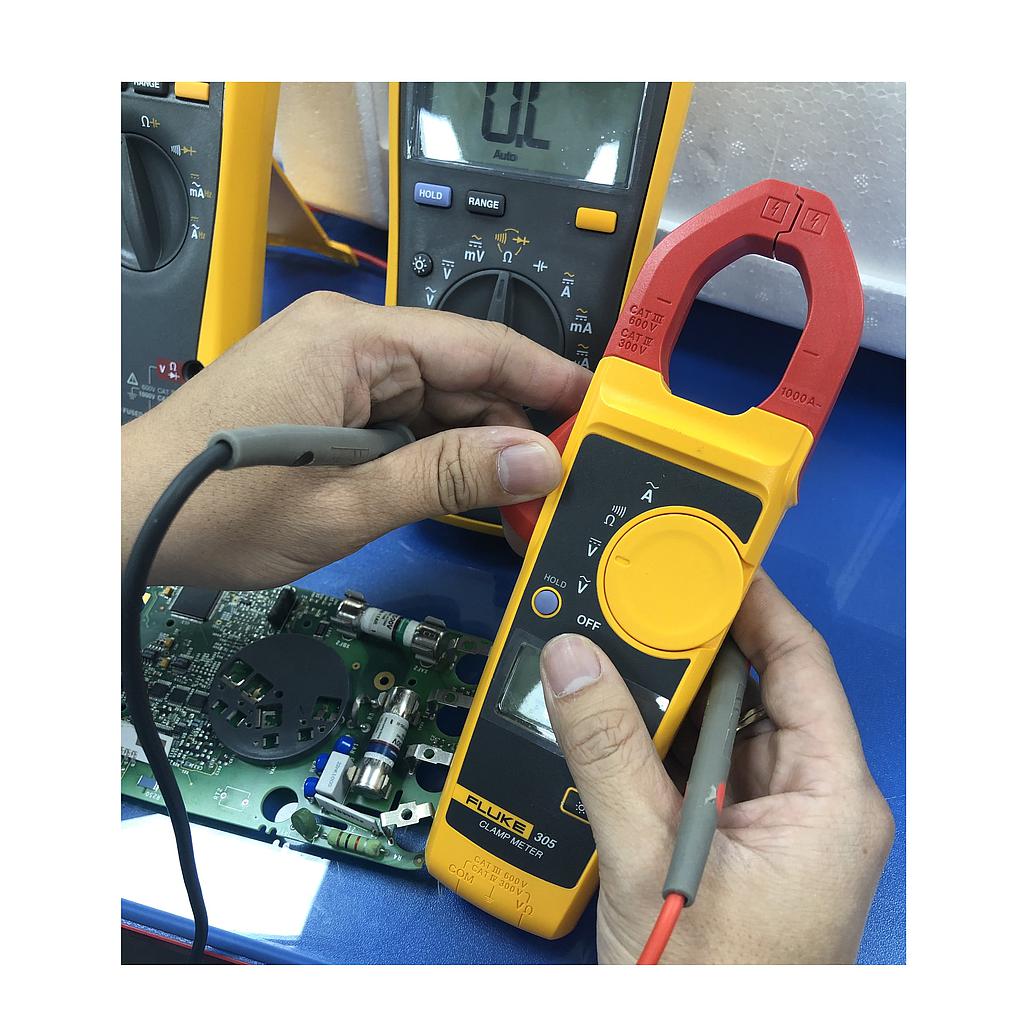 Technician handling an electrical measuring instrument during service and inspection