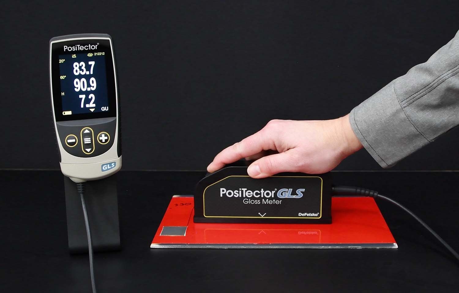 PosiTector GLS measuring gloss on a red painted test surface